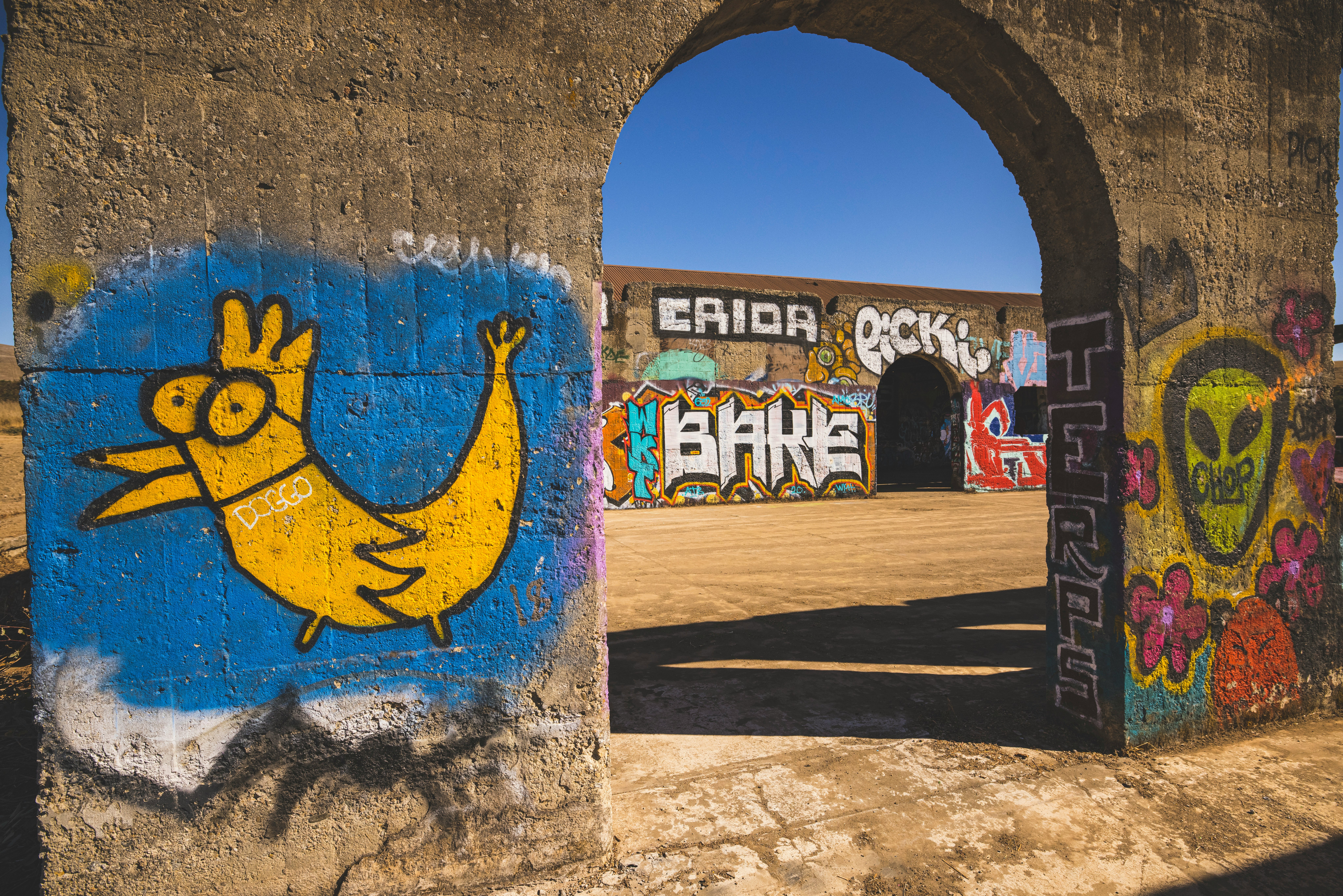 blue and yellow graffiti on wall